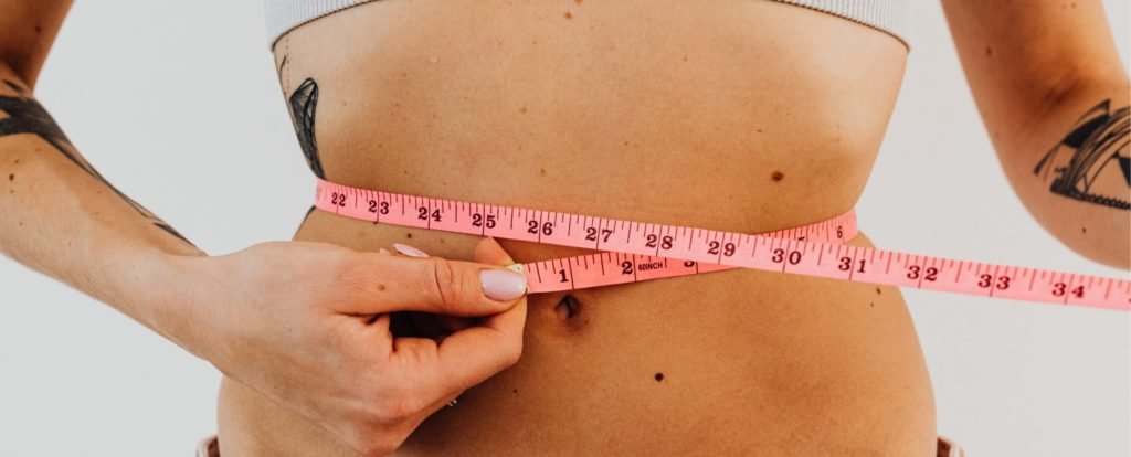 Measuring the waist with a tape measure